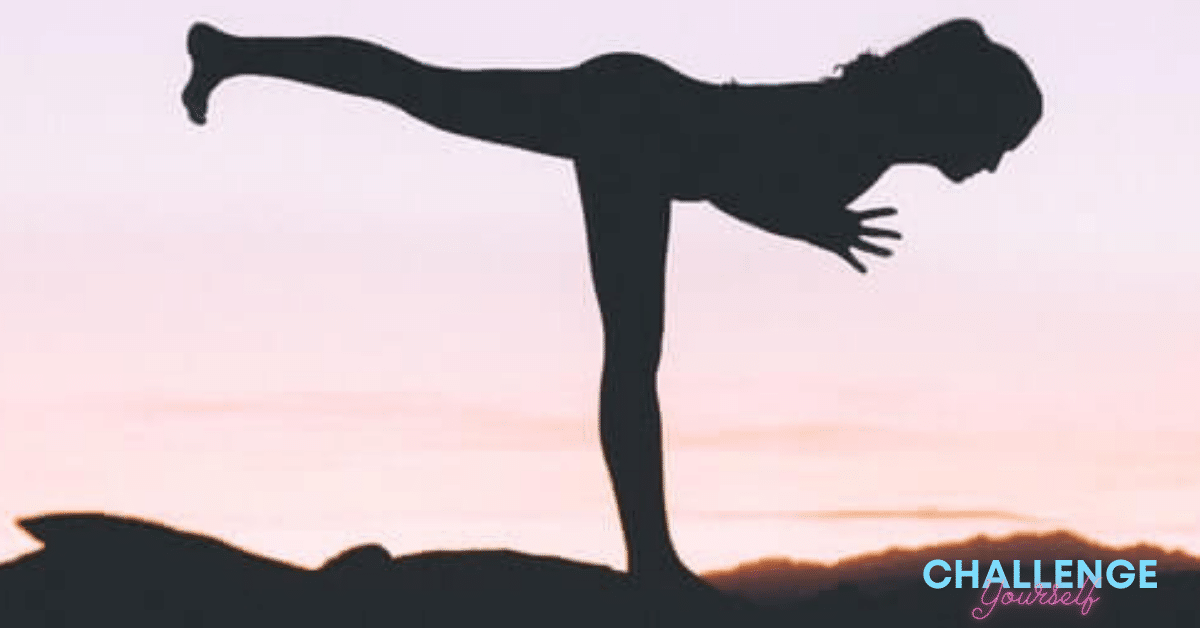 silhouette of a woman doing yoga at sunset.