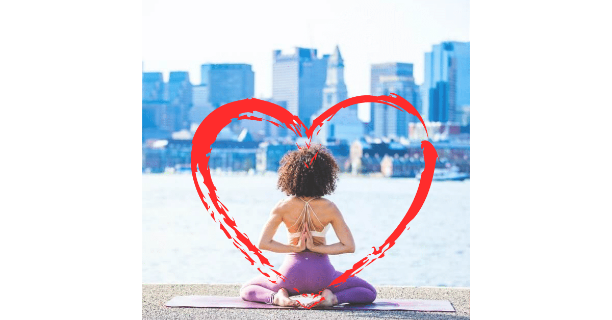 a woman in a pure yoga position amid a city-scape.